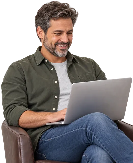 Man smiling while working on his laptop